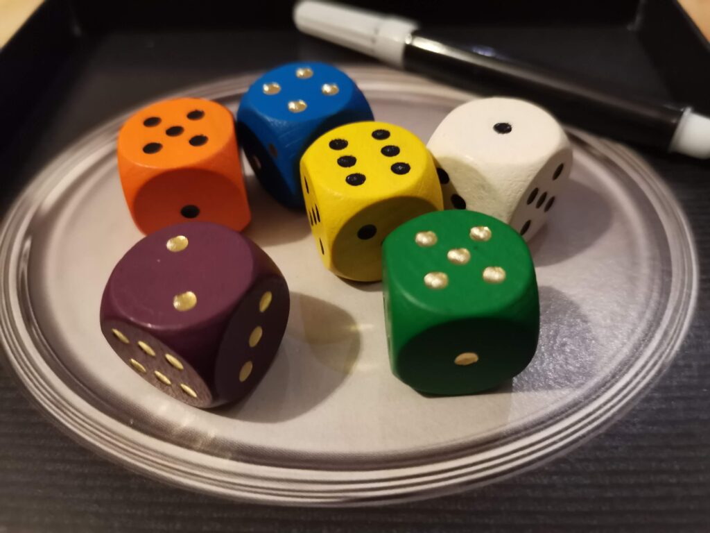 coloured dice on the silver tray