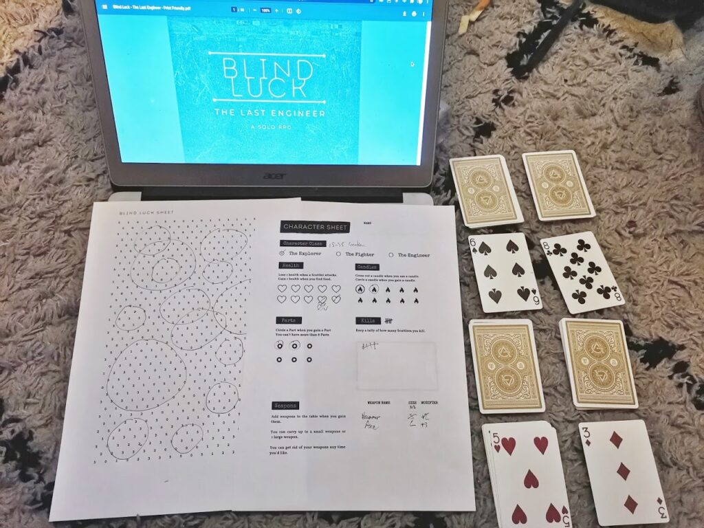 blind luck in play with cards and a laptop