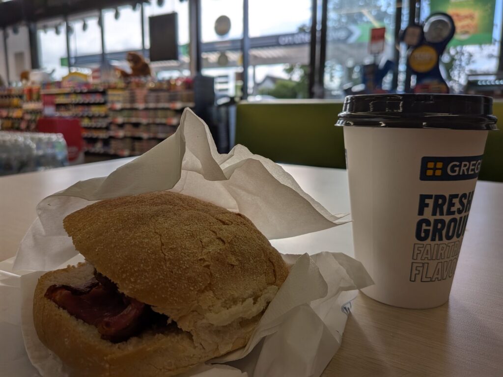 a breakfast roll and a cup of coffee