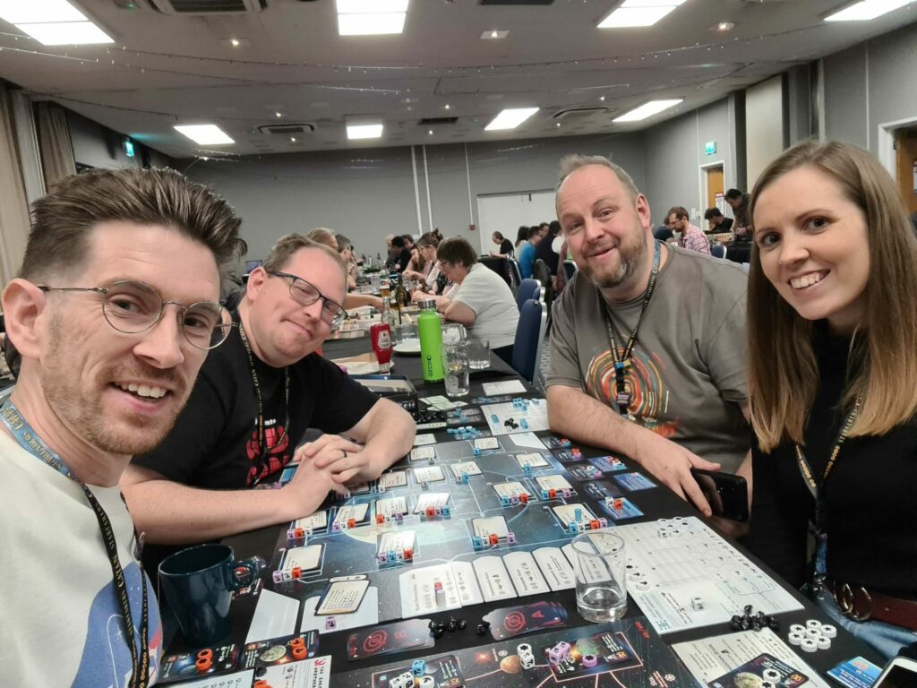 a group of players around a game of Beyond the Sun