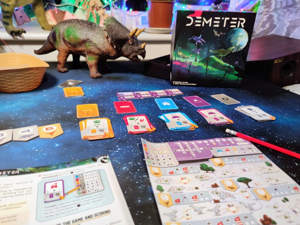 demeter being played, with a dinosaur on the table