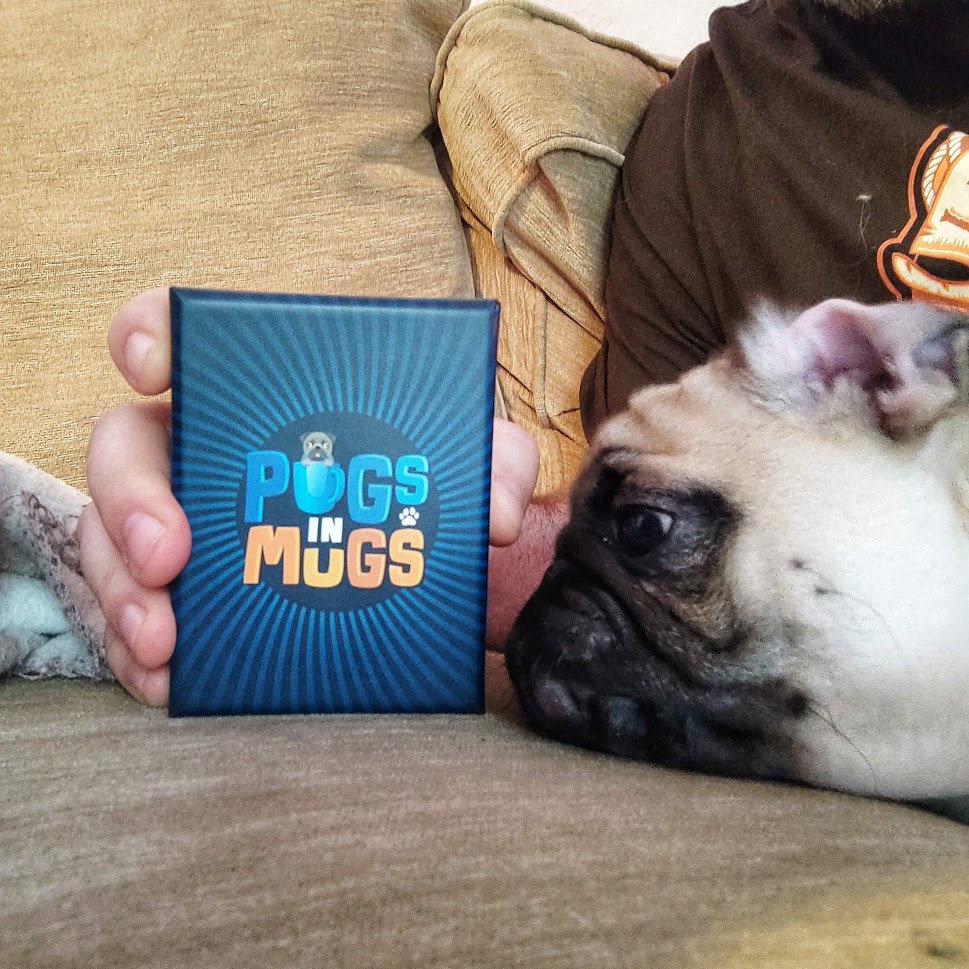 my pug jeff, looking at the game's box