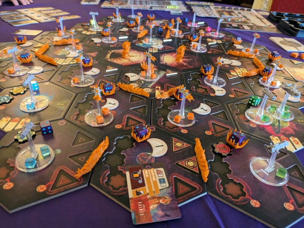 a game of voidfall being played, with spaceship miniatures all over the map