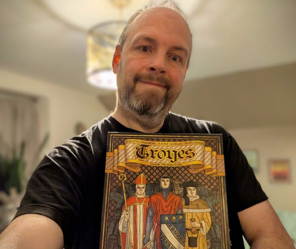 me holding my copy of Troyes