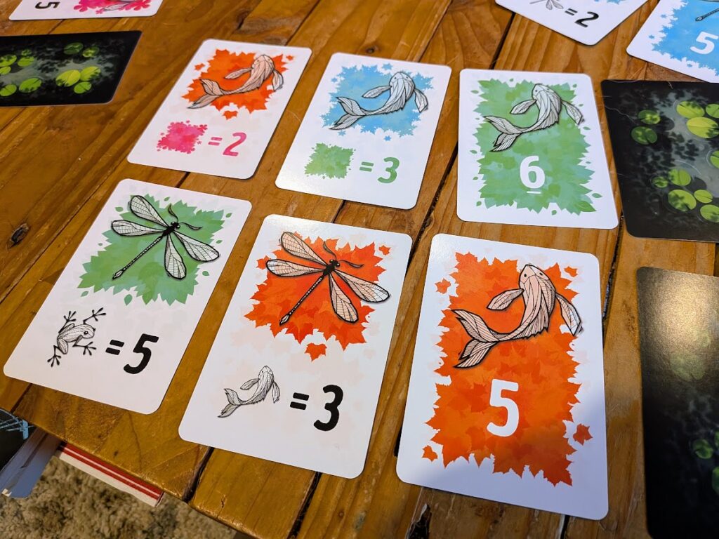 some cards in play on a table in Symbiosis